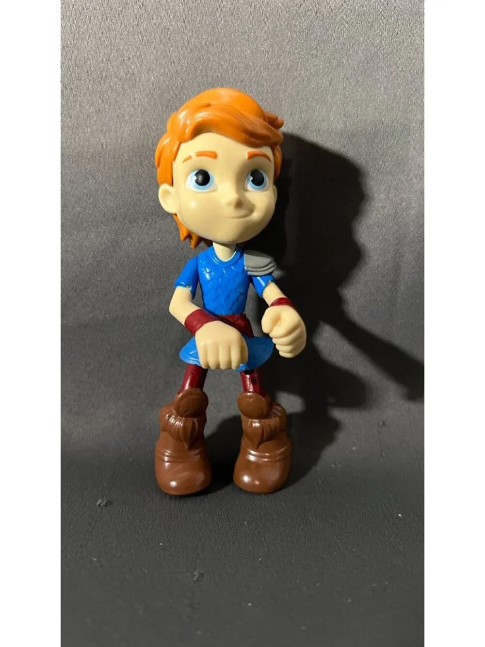 Red-Haired Action Figure In Blue Outfit With Brown Boots